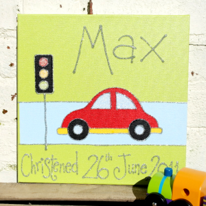 A personalised canvas picture of a red and yellow card stopped at the traffic lights on a blue road.