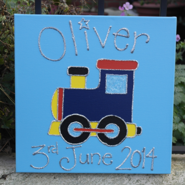 A personalised canvas picture of a dark blue, yellow and red train with big black wheels and blue windows on a blue background.