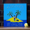 A personalised canvas picture of a pirate island complete with palm trees and yellow sand and a small pirate standing next to a treasure chest.