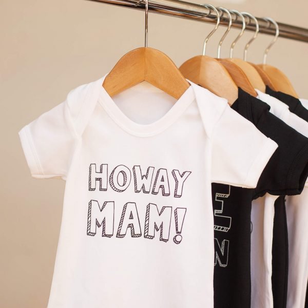 Baby vests with geordie slogans. This one says Howay Mam. It comes in black or white and sizes birth to 18