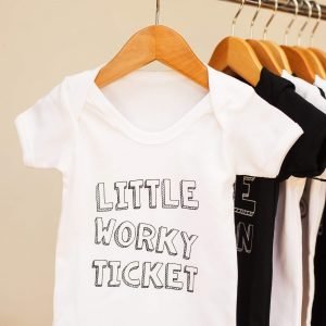 White cotton geordie baby vest with Little worky ticket on the front