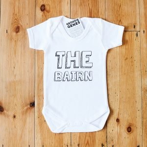White geordie baby vest with The Bairn on the front in a block font. The baby vest is available in black too and in sizes birth to 18 months