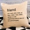 A cushion with the definition of Friend printed on it