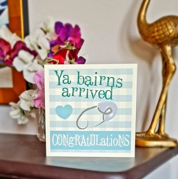 Geordie New Baby Boy card. A blue and white checked card with a blue heart and a blue safety pin. Ya bairns arrived congratulations