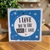 A geordie card with I love you to the toon and back printed in a big white moon on a blue starry background