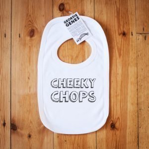 A white bib including poppers on the collar to fasten around babys neck with geordie saying cheeky cops on the front