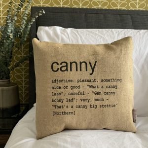 A North East inspired cushion made from hessian and backed with striped ticking. The cushion has a colloquial dictionary quote of what Canny means.