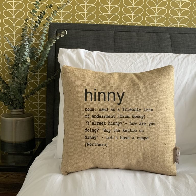 A North East inspired cushion made from hessian and backed with striped ticking. The cushion has a colloquial dictionary quote of what Hinny means.