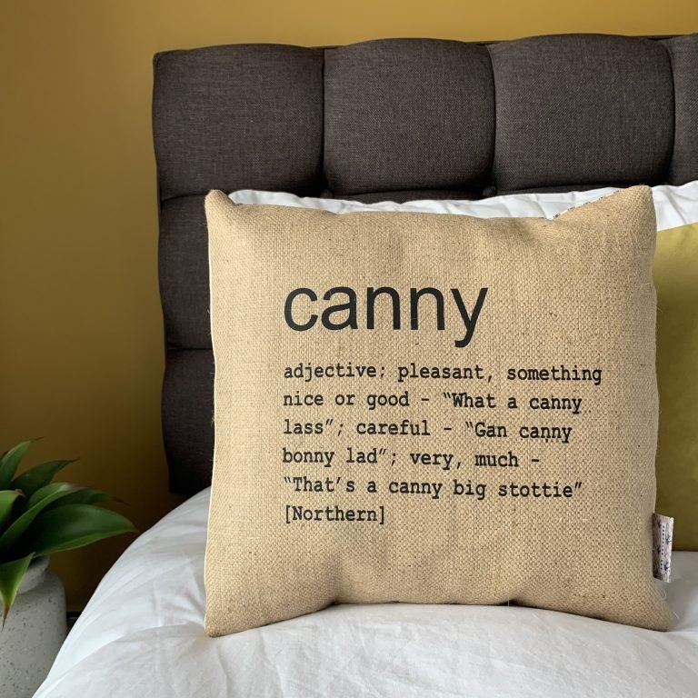 A North East inspired cushion made from hessian and backed with striped ticking. The cushion has a colloquial dictionary quote of what Canny means.