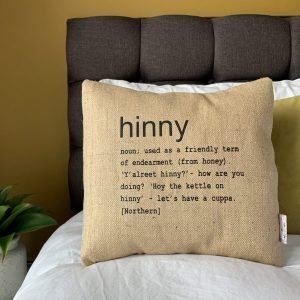 A North East inspired cushion made from hessian and backed with striped ticking. The cushion has a colloquial dictionary quote of what Hinny means.