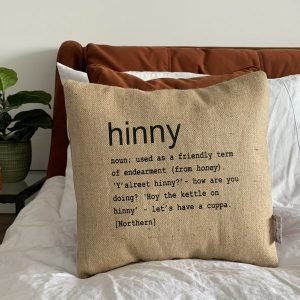 A North East inspired cushion made from hessian and backed with striped ticking. The cushion has a colloquial dictionary quote of what Hinny means.