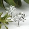 A pair of sterling silver tree of life intricate design stud earrings