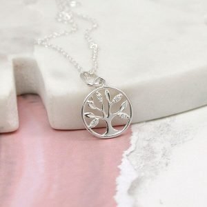 A sterling silver necklace with a tree of life pendant. The tree is enclosed in a circle and has textured leaves