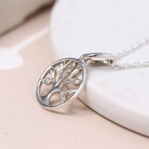 A sterling silver necklace with a tree of life pendant. The tree is enclosed in a circle and has textured leaves