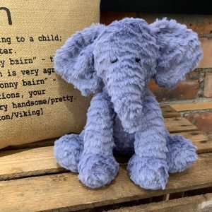 A gorgeous baby blue, tufted fur elephant. Floppy, large ears and a long hanging trunk with a short tail and stitched eyes.