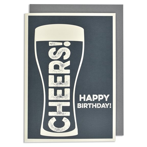 A cream card with black background and a pint glass embossed in cream print with the word cheers inside it. Happy Birthday is also embossed and printed in cream to the right of the beer glass.