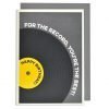 A cream card printed with a grey background and a black record with yellow label embossed on it. The words Happy Birthday are printed in black in the centre of the album on the label. The words For the record, You're the best are embossed and printed in a cream colour around the edge of the record.