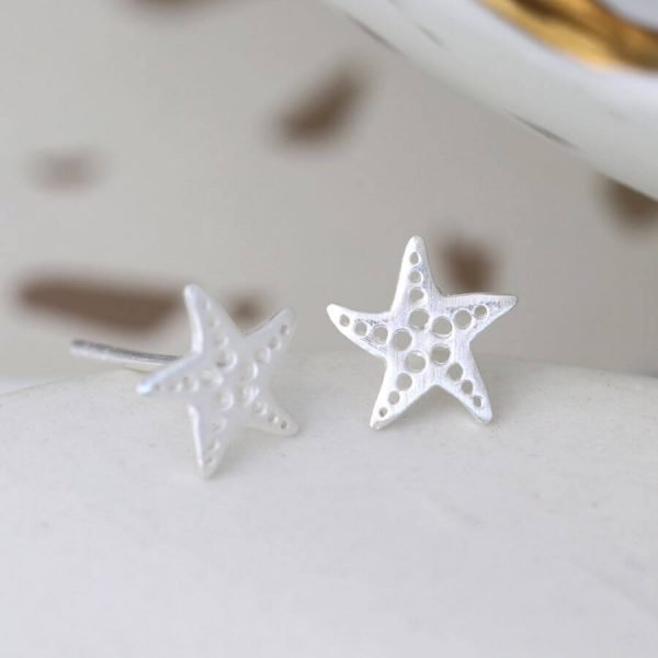 A delightful pair of sterling silver starfish earrings with intricate cut out dotty design.