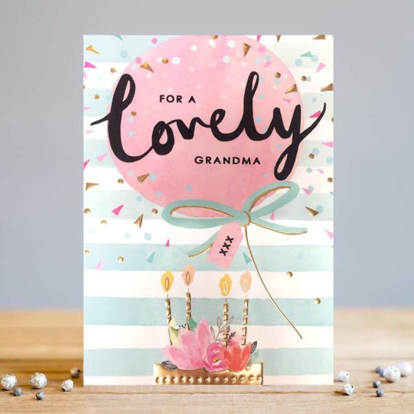 A greetings card with embossed and gold foiled detailing on a birthday cake with candles and a big balloon with the words for a lovely grandma