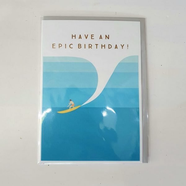 Greeting card with the message have an epic birthday and a contemporary image of a surfer catching a big turquoise wave.