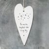 A cream porcelain hanging heart decoration stamped in black with stars and a moon and the words you are the brightest star in my sky