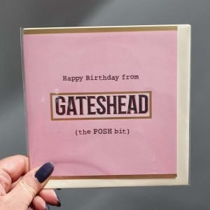 A pink card that reads Happy Birthday from Gateshead (the POSH bit)