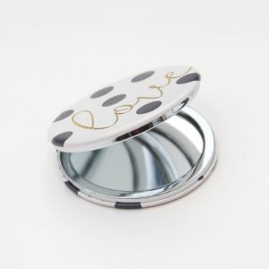 polka dot pocket compact mirror with love written in gold. Leather look with magnetic close and 2 mirrors, one magnifying