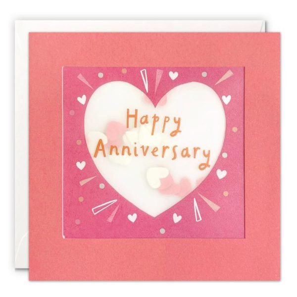 A square card with a pink border which holds in place a translucent packet which holds heart shaped confetti inside of it. A pink heart is printed on the translucent material along with the words Happy Anniversary.
