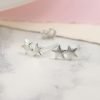A pair of silver double star earrings. The 2 little stars are welded together on one stem.