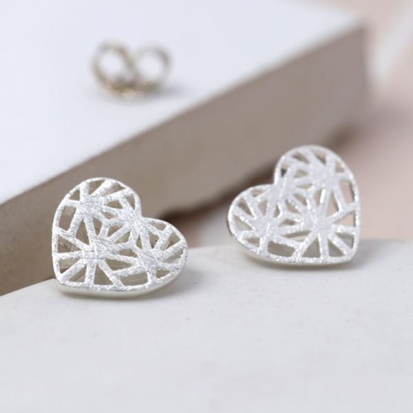A pair of silver lattice heart earrings with a scratched frosted finish.