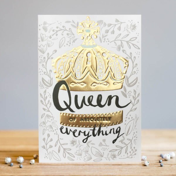 A rectangular card with white background with grey leaves, flowers and branches printed all over it. In the centre of the card is an embossed gold foil printed crown image. The wording Queen of Absolutely Everything are printed in black at the bottom of the crown.