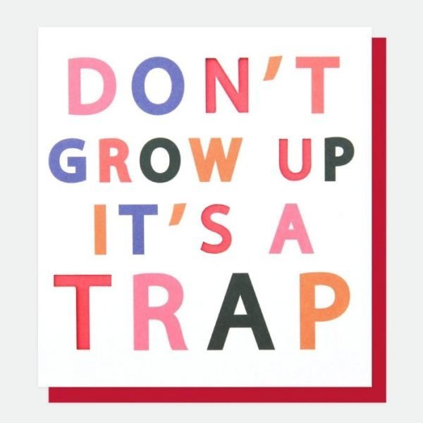 A designer typographic birthday card from Caroline Gardner. A white card with DON'T GROW UP IT'S A TRAP in colourful letters with some of the letters being punched out.