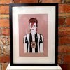 A print of David Bowie wearing a Newcastle United football top