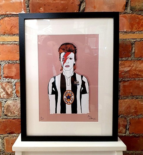 A print of David Bowie wearing a Newcastle United football top