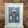 an a4 print of an illustration of a stormtrooper wearing a newcastle united football top