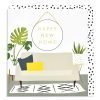 A square card with a sofa on it with cushions, a rug on the floor and lovely plants. On the wall is a large circular mirror which has the wording Happy New Home on it.