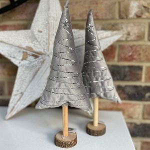 A lovely silver plush tree on a wooden trunk and base. There is a sequin pattern zigzagging down the tree giving added silver sparkle.