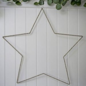 A 75cm sparkly star which is made from wire creating an outline of a star and covered in little sparkly beads. The star is hung with a white ribbon.