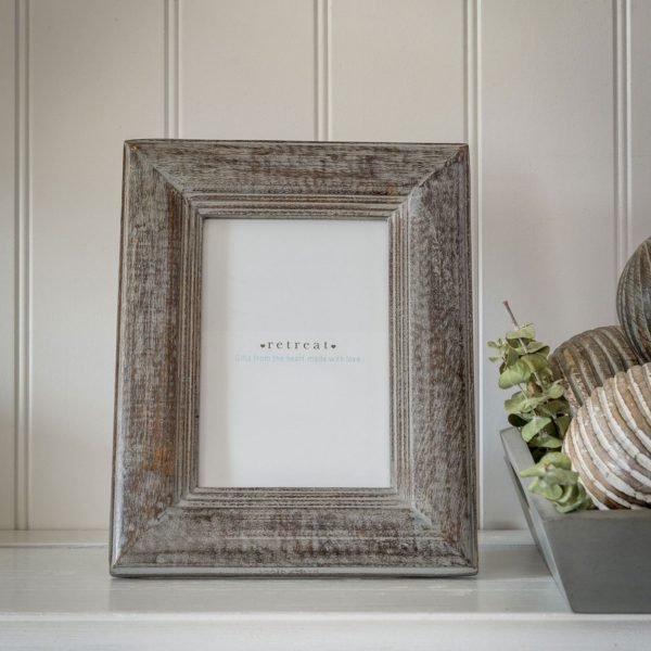 A grey washed wooden bevelled picture frame.