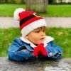 Santa Christmas Hat and Mittens Set. A red knitted hat with a white pom pom and white trim with santa's belt and a pair of matching red knitted mittens