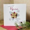 A Christmas card for Nana with a poinsiettia design. The flower has a wooden cut out centre