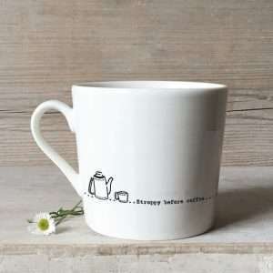 A white porcelain mug with the words stroppy before coffee