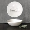 A cream ceramic little dish with a black line drawing of a caravan and the words Good friends, great adventures