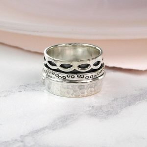 Hand crafted spinning ring made from fine quality sterling silver with decorative edges and double silver moving bands
