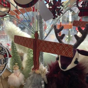 A wooden Angel of the North hanging tree decoration in rust and white scandi pattern