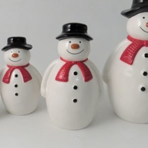 A ceramic snowman Christmas decoration with a black hat and red scarf