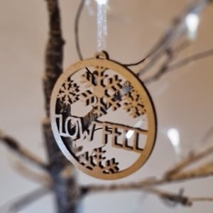 A circular laser cut wooden tree decoration in metallic silver. With beautiful snowflakes and the words Low Fell.
