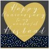 A husband anniversary card with a big gold heart on a dark background and happy anniversary to my wonderful husband