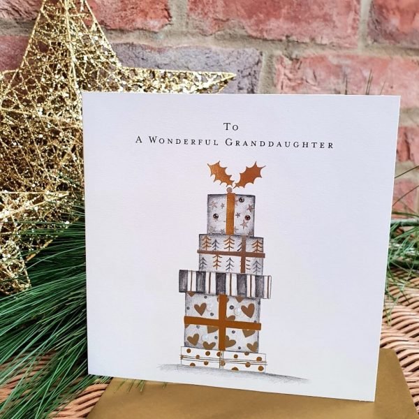 A luxury Christmas card with a pencil drawing of a pile of wrapped gifts. With gold and silver foiling and crystals and To a wonderful granddaughter
