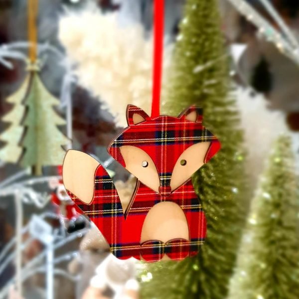A wooden hanging fox decoration in natural wood and tartan